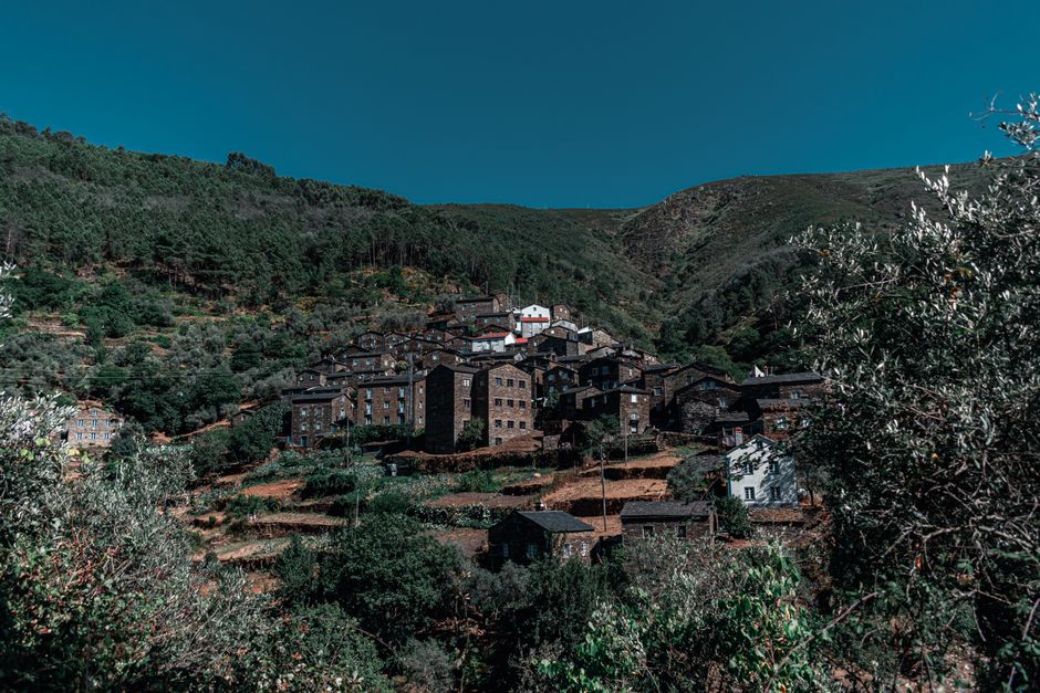 Picturesque mountain village with traditional houses under a clear blue sky.