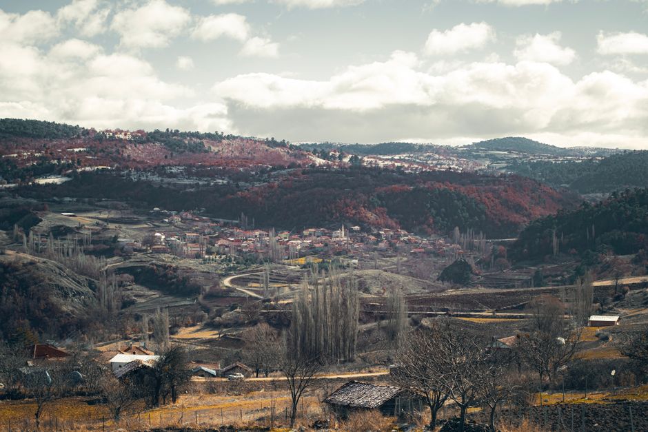 Picturesque rural village nestled among rolling hills in autumn season.
